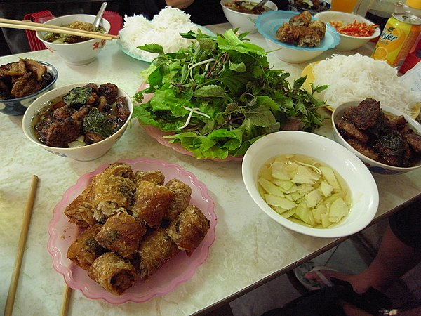 A serving of bún chả — grilled pork patties with rice noodles, herbs and dipping broth
